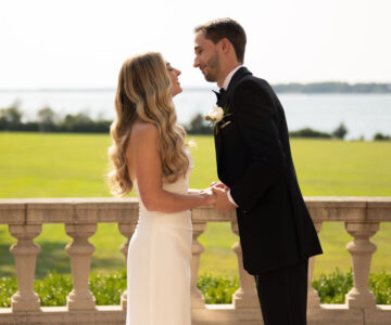 Bride and groom sharing a kiss outdoors on wedding day.