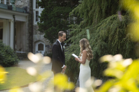 A couple exchanging vows outdoors during their wedding ceremony.